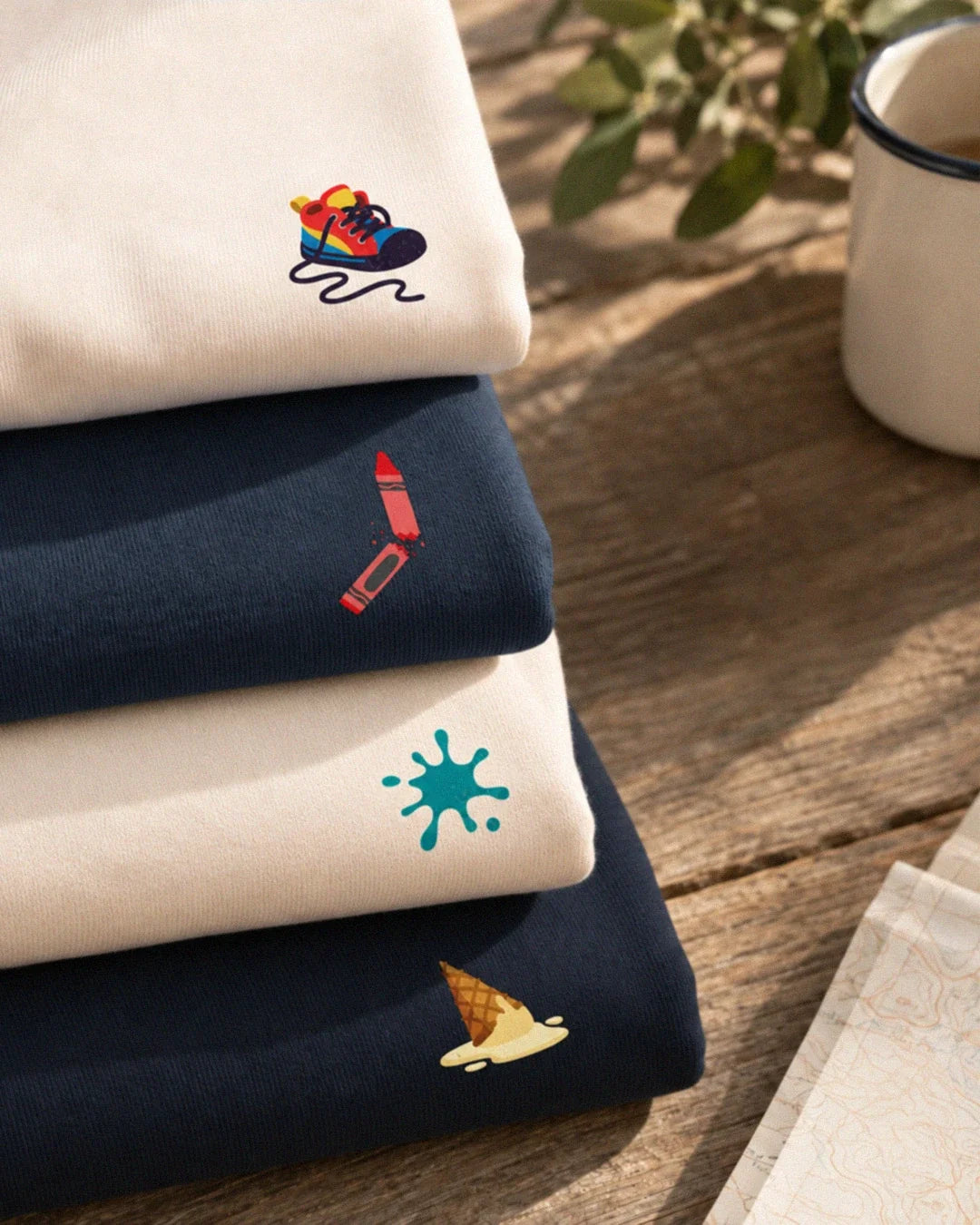 Stack of kids sweatshirts from the Oups Minis collection by Tout Est Fichu